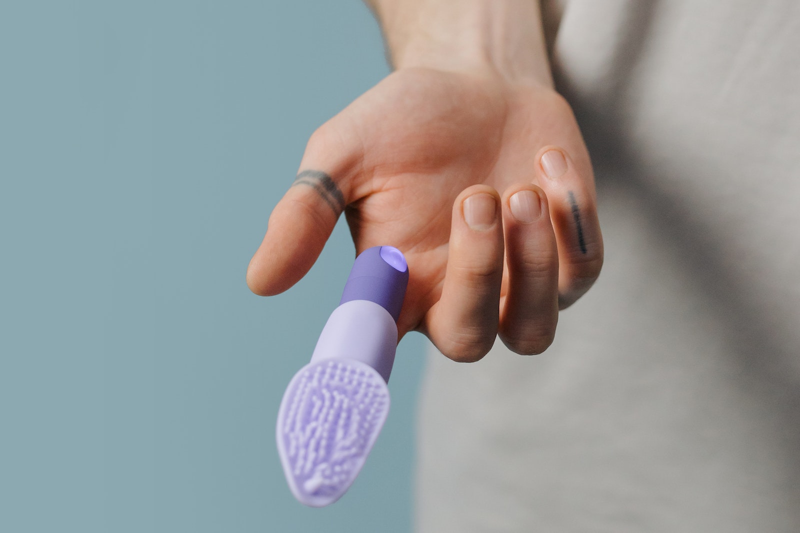 Purple Finger Vibrator in the Person's Finger