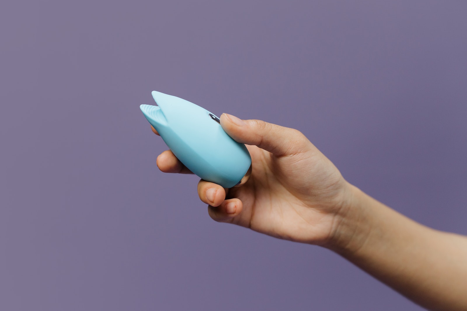A Person Holding a Blue Sex Toy