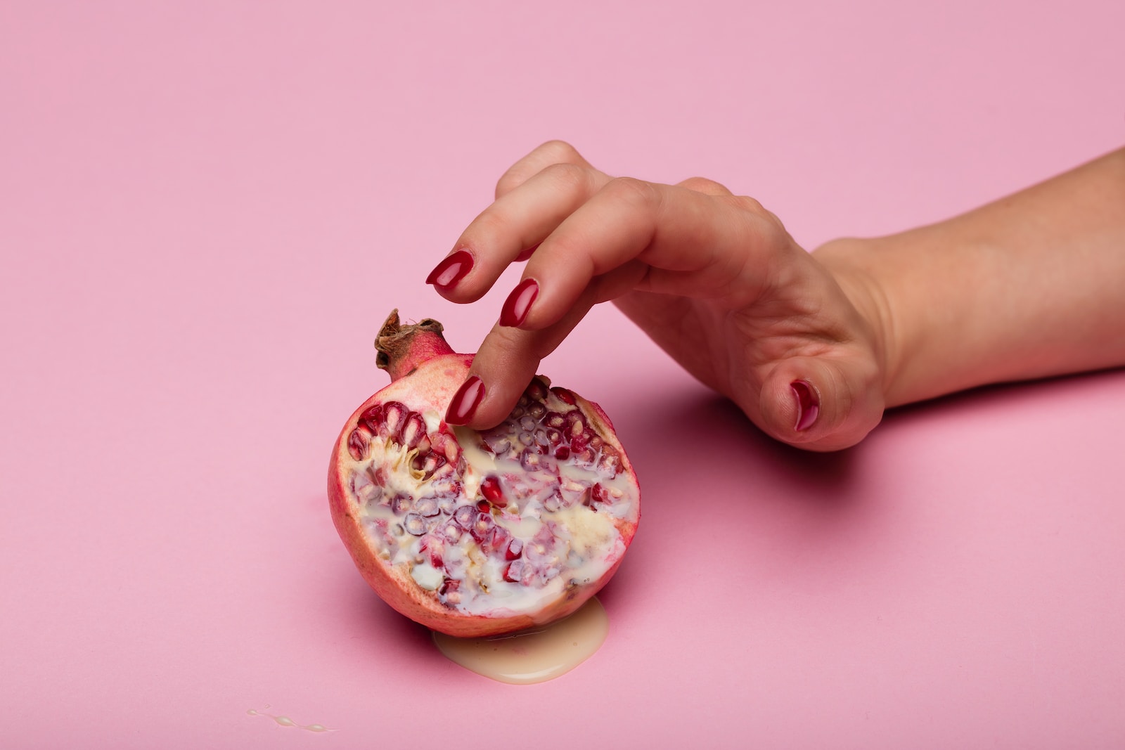 person holding a pink doughnut